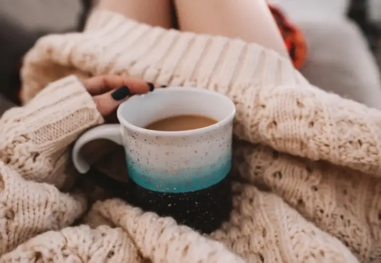 woman holding cup of coffee